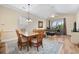 Cozy dining area adjacent to a living room with hardwood floors and natural light at 139 Avian Dr. # 6-201, Pawleys Island, SC 29585