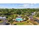 Aerial view of a community pool surrounded by lush landscaping, lounge chairs, and clear blue skies at 139 Avian Dr. # 6-201, Pawleys Island, SC 29585