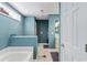 View of bathroom with tub and vanity featuring tile floors and blue walls at 140 Pixie Dust Ct., Myrtle Beach, SC 29588