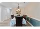 Formal dining room with chandelier lighting has seating for six and wainscotting on the lower portion of the walls at 140 Pixie Dust Ct., Myrtle Beach, SC 29588