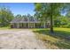 Charming home with a welcoming front porch and well-maintained lawn and gravel driveway at 140 Pixie Dust Ct., Myrtle Beach, SC 29588