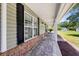 Extended front porch with brick accents, decorative columns, and outdoor lighting, offering a welcoming space at 140 Pixie Dust Ct., Myrtle Beach, SC 29588