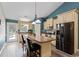 Modern kitchen features an island with bar stool seating, stainless steel appliances and granite countertops at 140 Pixie Dust Ct., Myrtle Beach, SC 29588