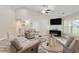 Bright living room with vaulted ceiling, comfortable seating and a cozy fireplace for relaxation at 140 Pixie Dust Ct., Myrtle Beach, SC 29588