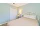 Inviting bedroom with soft blue walls, a comfortable bed, a closet, and a bedside table with a decorative lamp at 1450 St. George Ln. # E, Myrtle Beach, SC 29588
