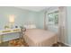 Cozy bedroom features a comfortable bed, stylish decor, a window with sunlight, and a bedside table with a lamp at 1450 St. George Ln. # E, Myrtle Beach, SC 29588