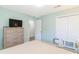 Well-lit bedroom with a bed, dresser with a TV, closet, and a door, creating a comfortable and functional space at 1450 St. George Ln. # E, Myrtle Beach, SC 29588