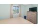 Serene bedroom offers a bed, window with natural light, and ample storage space with a dresser and a suitcase at 1450 St. George Ln. # E, Myrtle Beach, SC 29588