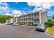 Attractive condo building with three stories of units and balconies, surrounded by a parking lot at 1450 St. George Ln. # E, Myrtle Beach, SC 29588