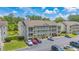 Attractive condo building with three stories of units and balconies, surrounded by lush green trees at 1450 St. George Ln. # E, Myrtle Beach, SC 29588