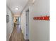 Bright hallway featuring wood floors, neutral walls, and a convenient coat rack near the entrance at 1450 St. George Ln. # E, Myrtle Beach, SC 29588