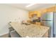 Kitchen featuring stainless steel appliances, a breakfast bar with granite countertops, and ample cabinet space at 1450 St. George Ln. # E, Myrtle Beach, SC 29588