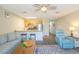 Open-concept living room featuring ceiling fan, breakfast bar, couch, and an accent chair at 1450 St. George Ln. # E, Myrtle Beach, SC 29588