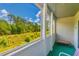 Relaxing screened-in porch with a view of lush greenery and a comfortable seating area at 1450 St. George Ln. # E, Myrtle Beach, SC 29588