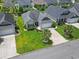 Aerial view of a single-story home with an attached garage, landscaping, and a well-maintained lawn at 155 Palmetto Green Dr., Longs, SC 29568