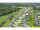 Aerial view of the community showing neighborhood streets, landscaping, a pool and nearby golf course at 155 Palmetto Green Dr., Longs, SC 29568
