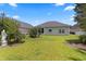 The backyard features lush green grass, a well-maintained lawn, and a variety of plants and bushes at 155 Palmetto Green Dr., Longs, SC 29568