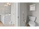 Well-lit bathroom with white vanity, toilet, and a decorative light fixture above the sink at 155 Palmetto Green Dr., Longs, SC 29568