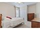 Bedroom with a bed, white comforter, dresser, and a closet, complemented by neutral walls and carpet at 155 Palmetto Green Dr., Longs, SC 29568