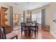 Bright dining room with wood floors, elegant lighting, and access to a screened porch at 155 Palmetto Green Dr., Longs, SC 29568