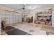 Spacious garage with an open garage door and storage shelves, providing ample space for vehicles and storage at 155 Palmetto Green Dr., Longs, SC 29568