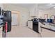 Well-lit kitchen featuring black appliances, granite countertops, and ample cabinet space at 155 Palmetto Green Dr., Longs, SC 29568