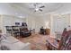 Open-concept living area featuring hardwood floors, a ceiling fan, and a seamless flow to the kitchen at 155 Palmetto Green Dr., Longs, SC 29568