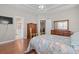 Spacious main bedroom with hardwood floors, ensuite bathroom, and large dresser at 155 Palmetto Green Dr., Longs, SC 29568