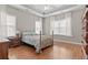 Well-lit main bedroom with hardwood floors and ample natural light from large windows at 155 Palmetto Green Dr., Longs, SC 29568