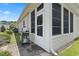 Back patio and screened in porch area with a gas grill, ideal for outdoor cooking and relaxation at 155 Palmetto Green Dr., Longs, SC 29568