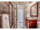 Bathroom featuring a tiled shower with glass door and a vanity with modern fixtures at 1733 24Th Ave. N, North Myrtle Beach, SC 29582