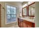 Bright bathroom featuring double sinks, granite countertops, and wood cabinets at 1733 24Th Ave. N, North Myrtle Beach, SC 29582
