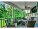Inviting screened porch featuring comfortable wicker furniture and a ceiling fan for relaxing outdoors at 1733 24Th Ave. N, North Myrtle Beach, SC 29582