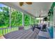 Comfortable screened-in porch featuring an outdoor dining table and wicker furniture, ideal for relaxation at 1733 24Th Ave. N, North Myrtle Beach, SC 29582