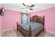 Inviting bedroom featuring a large bed, a ceiling fan, and ample natural light at 180 Weeping Willow Dr., Myrtle Beach, SC 29579