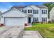 Charming two-story home with attached garage and well-maintained lawn and solar panels at 180 Weeping Willow Dr., Myrtle Beach, SC 29579