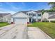 Charming two-story home featuring white siding, black shutters, solar panels, and a spacious driveway at 180 Weeping Willow Dr., Myrtle Beach, SC 29579
