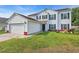 Inviting two-story home with white siding, black shutters, green lawn and solar panels at 180 Weeping Willow Dr., Myrtle Beach, SC 29579