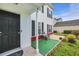 Cozy front porch featuring a table, chairs, artificial turf and lush landscaping at 180 Weeping Willow Dr., Myrtle Beach, SC 29579