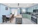 Modern kitchen features blue walls, stainless steel appliances, an island, and a dining area at 180 Weeping Willow Dr., Myrtle Beach, SC 29579