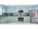 Well-equipped kitchen featuring stainless steel appliances, sleek countertops and modern cabinets at 180 Weeping Willow Dr., Myrtle Beach, SC 29579