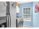 Bright laundry room features modern washer/dryer, storage cabinets, and a window for natural light at 180 Weeping Willow Dr., Myrtle Beach, SC 29579