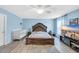 Bright main bedroom with hardwood floors, decorative rug, a large bed, and a television at 180 Weeping Willow Dr., Myrtle Beach, SC 29579
