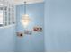 Light blue staircase highlighted by an ornate chandelier and decorative wall art at 180 Weeping Willow Dr., Myrtle Beach, SC 29579