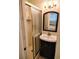 Bathroom boasts a standup shower and vanity with a dark cabinet and modern sink at 1919 Spring St. # B12, North Myrtle Beach, SC 29582