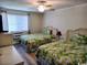 Relaxing bedroom with two beds, tropical bedding, and plenty of natural light at 1919 Spring St. # B12, North Myrtle Beach, SC 29582