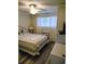 Comfortable bedroom featuring a bed, ceiling fan, bright window, and beach-themed decor at 1919 Spring St. # B12, North Myrtle Beach, SC 29582