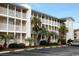 Charming condo complex with multiple floors, balconies, parking, and lush landscaping at 1919 Spring St. # B12, North Myrtle Beach, SC 29582