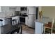 Well-equipped kitchen with stainless steel appliances, granite counters, and dining area at 1919 Spring St. # B12, North Myrtle Beach, SC 29582