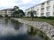 Peaceful community with water views, rock wall bordering the pond, and lush landscaping at 1919 Spring St. # B12, North Myrtle Beach, SC 29582